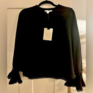Pomander Place black top with detail around cuffs and bottom of top. Never worn.